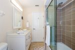 Upgraded guest bathroom with tub/shower and glass enclosure